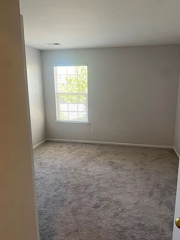 18203 Adri Cir, Walled Lake, MI 48390 - carpeted empty room with baseboards