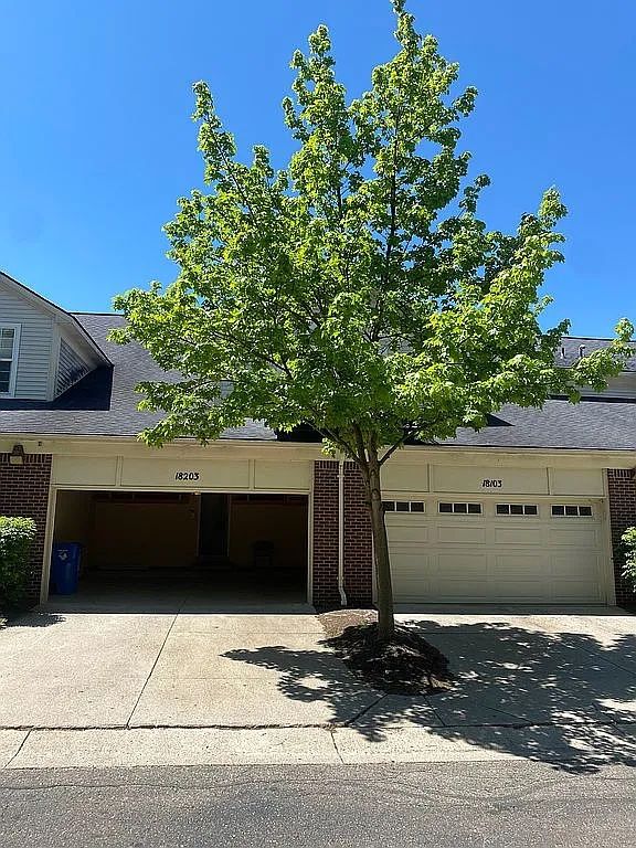 18203 Adri Cir, Walled Lake, MI 48390 - view of front facade with brick siding and driveway