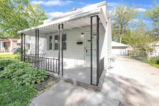 exterior space with covered porch and fence