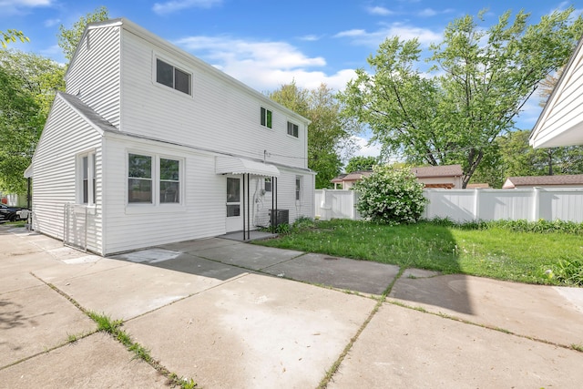 rear view of house featuring fence, a patio area, and central AC unit