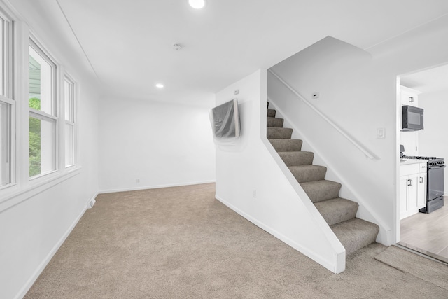 staircase with carpet, baseboards, and recessed lighting