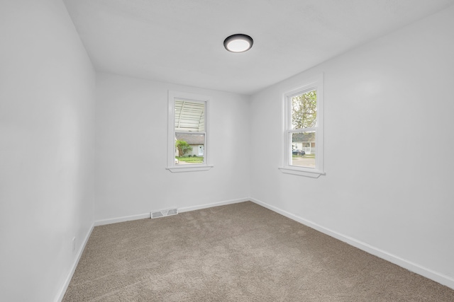 carpeted spare room with baseboards