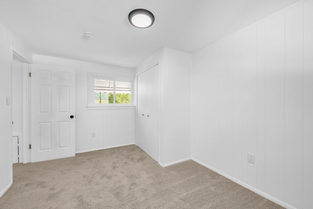 carpeted spare room featuring baseboards
