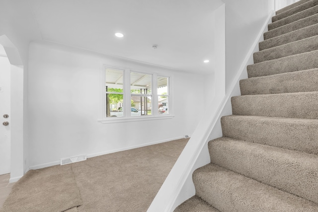 stairs featuring carpet flooring, recessed lighting, baseboards, and arched walkways