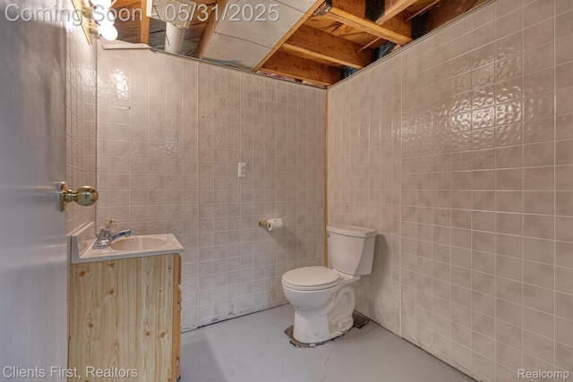 1384 Cambridge Rd, Berkley, MI 48072 - bathroom featuring toilet, vanity, tile walls, and concrete floors