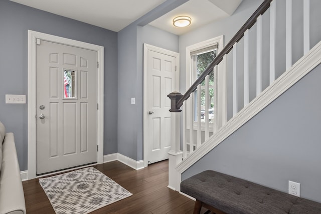 entrance foyer with stairway, baseboards, and dark wood-style flooring