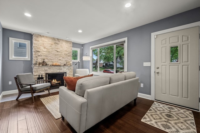 living area featuring a fireplace, baseboards, dark wood finished floors, and recessed lighting
