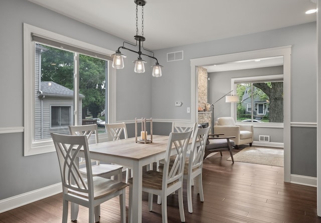 dining room with wood finished floors, baseboards, and recessed lighting