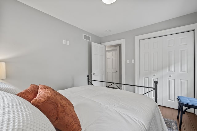 bedroom featuring wood finished floors and a closet