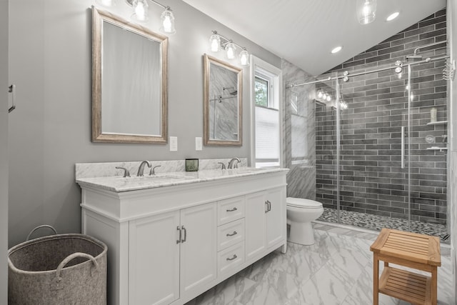 bathroom with vaulted ceiling, marble finish flooring, a stall shower, double vanity, and toilet