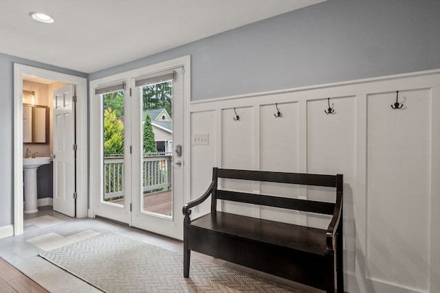 mudroom featuring a wainscoted wall, a decorative wall, and recessed lighting