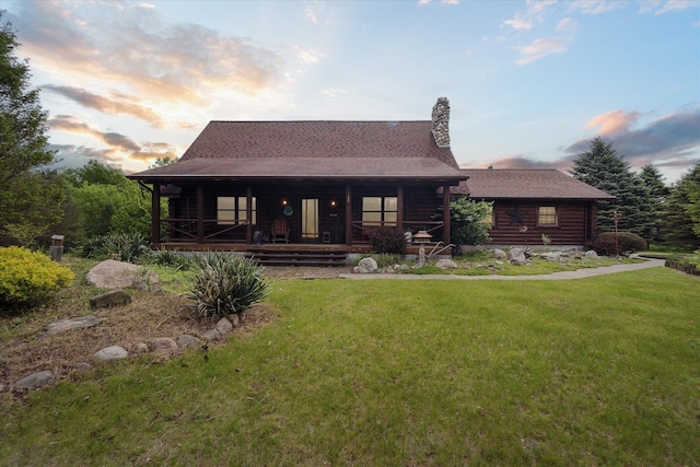 5114 N Oak Rd, Davison, MI 48423 - view of front of property featuring a lawn, log exterior, roof with shingles, a porch, and a chimney