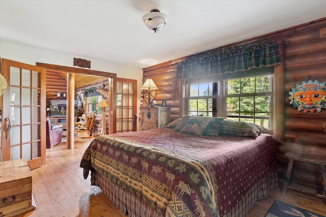 5114 N Oak Rd, Davison, MI 48423 - bedroom featuring rustic walls, french doors, and wood-type flooring