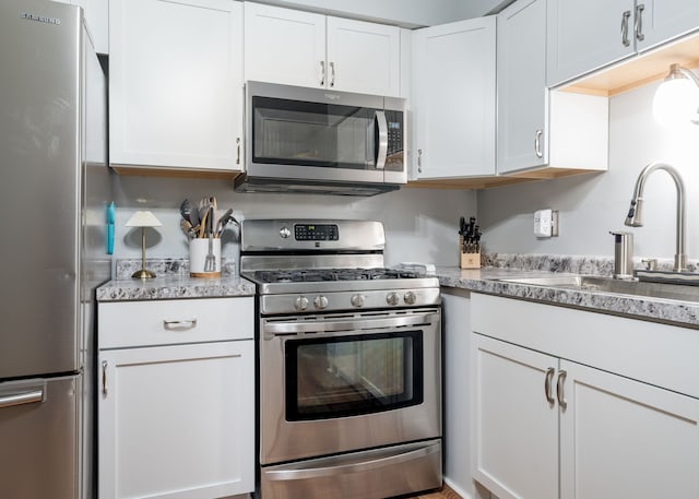 39596 Old Dominion Dr, Clinton Township, MI 48038 - kitchen featuring appliances with stainless steel finishes, a sink, and white cabinets