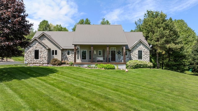 7918 Dan Patch Dr, Jackson, MI 49201 - view of front of home featuring stone siding, a front lawn, a standing seam roof, and metal roof