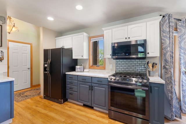 7918 Dan Patch Dr, Jackson, MI 49201 - kitchen featuring appliances with stainless steel finishes, white cabinets, light wood finished floors, light countertops, and recessed lighting