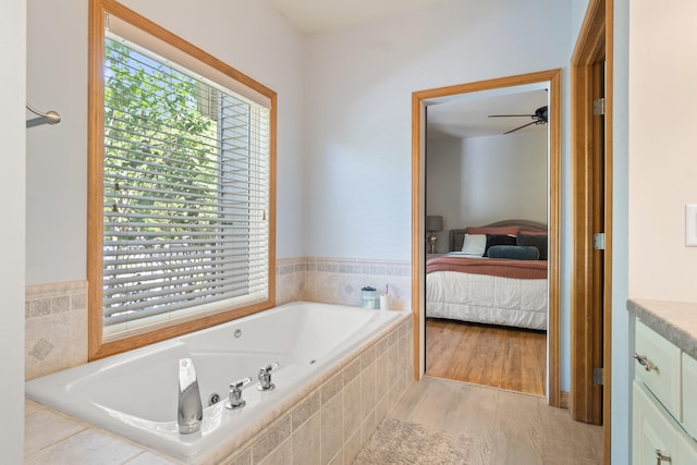 7918 Dan Patch Dr, Jackson, MI 49201 - bathroom with a jetted tub, a ceiling fan, connected bathroom, and vanity