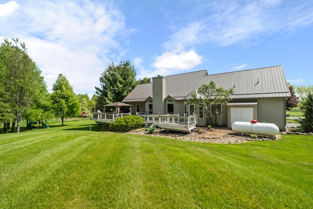 7918 Dan Patch Dr, Jackson, MI 49201 - rear view of house featuring a deck, a chimney, a yard, and metal roof