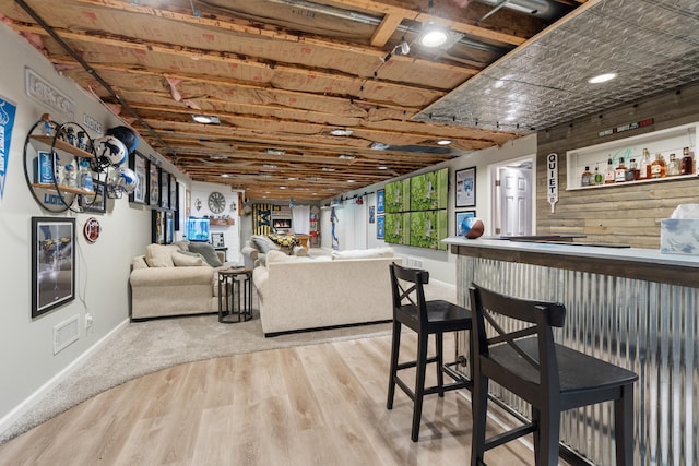 7918 Dan Patch Dr, Jackson, MI 49201 - living area with a dry bar, baseboards, and wood finished floors