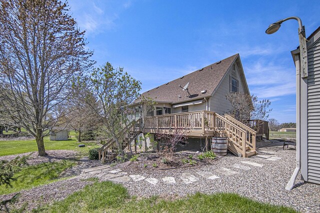 12499 Wilbur Rd, Clinton, MI 49236 - rear view of house featuring stairway, a wooden deck, and roof with shingles