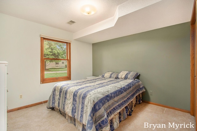 607 Crestview St, Holland, MI 49423 - bedroom with light carpet, baseboards, and a textured ceiling