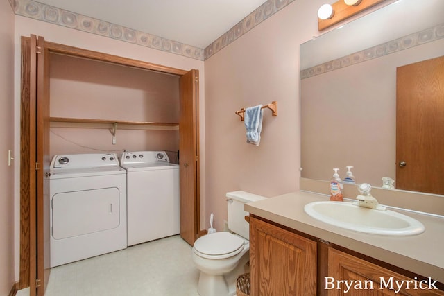 607 Crestview St, Holland, MI 49423 - bathroom featuring washer and clothes dryer, tile patterned floors, toilet, and vanity