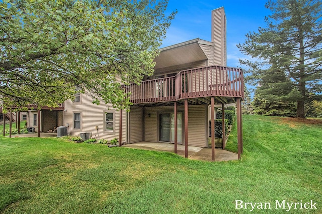607 Crestview St, Holland, MI 49423 - back of property featuring central AC unit, a deck, a patio, a lawn, and a chimney