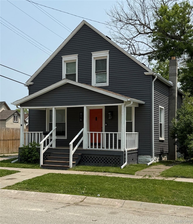 816 12th St, Port Huron, MI 48060 - view of front of home featuring covered porch and a chimney