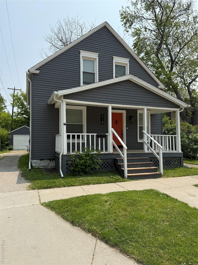 816 12th St, Port Huron, MI 48060 - bungalow featuring covered porch and a front yard