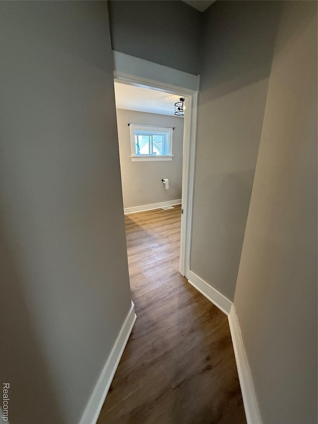 816 12th St, Port Huron, MI 48060 - hallway featuring baseboards and dark wood-style flooring