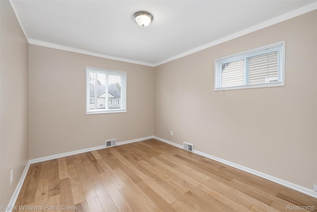 12777 Sherman Ave, Warren, MI 48089 - empty room featuring light wood-type flooring, crown molding, and baseboards