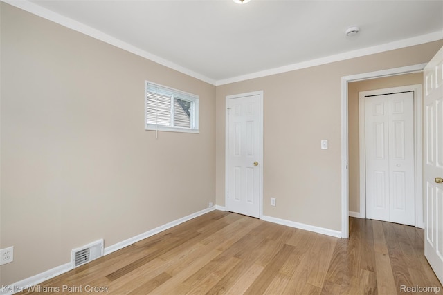 12777 Sherman Ave, Warren, MI 48089 - unfurnished bedroom with light wood finished floors, ornamental molding, and baseboards