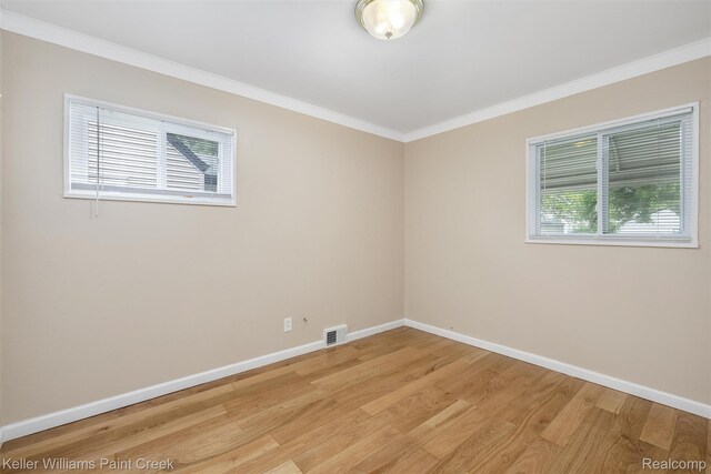 12777 Sherman Ave, Warren, MI 48089 - unfurnished room featuring crown molding, baseboards, and light wood-style floors