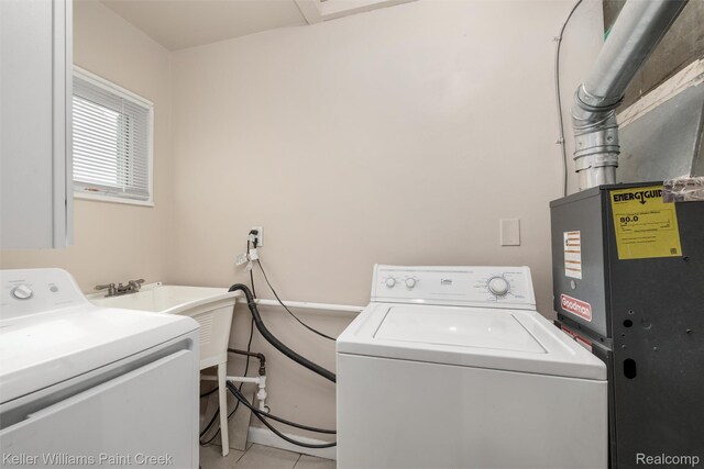 12777 Sherman Ave, Warren, MI 48089 - laundry room with light tile patterned floors, washer and dryer, and heating unit