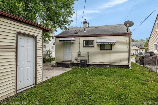 12777 Sherman Ave, Warren, MI 48089 - rear view of house with a chimney and central AC unit