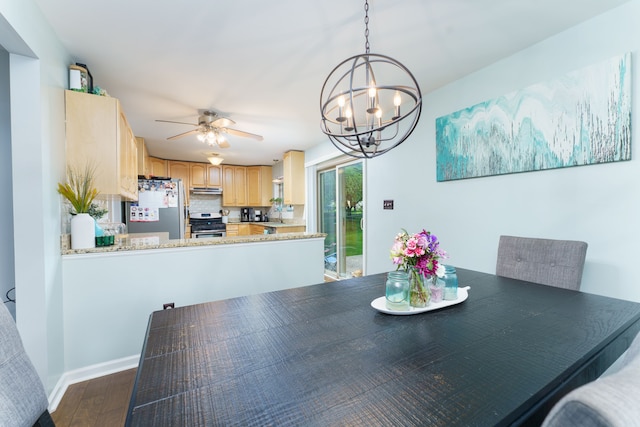 dining space featuring a chandelier, wood finished floors, and ceiling fan