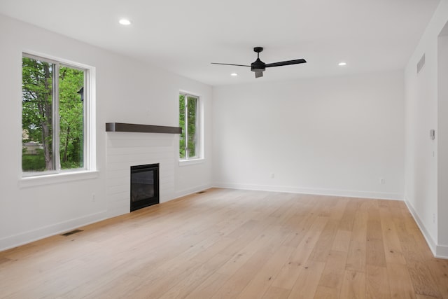 47309 Jefferson Ave, Chesterfield, MI 48047 - unfurnished living room with light wood-type flooring, a ceiling fan, a glass covered fireplace, baseboards, and recessed lighting