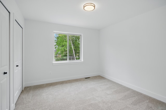 47309 Jefferson Ave, Chesterfield, MI 48047 - unfurnished bedroom featuring light colored carpet, baseboards, and a closet