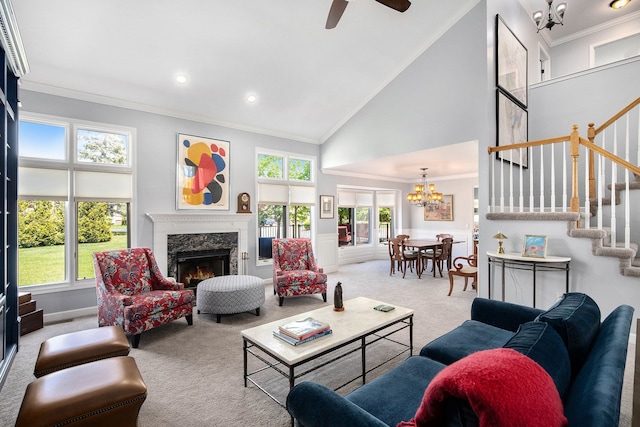 5200 Bridge Trl W, Commerce Twp, MI 48382 - carpeted living area featuring a chandelier, ornamental molding, stairs, a premium fireplace, and a towering ceiling