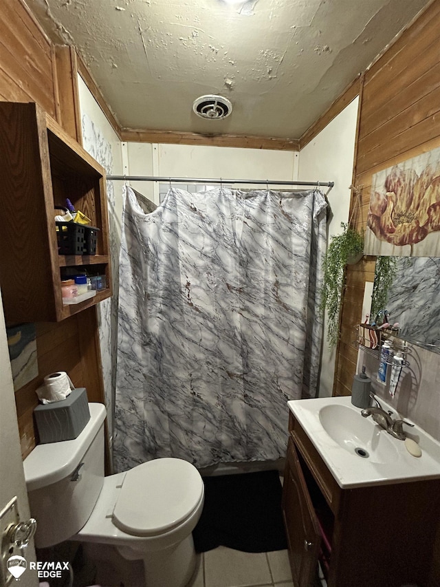 1634 Delaware St, Saginaw, MI 48602 - bathroom with toilet, wood walls, vanity, and curtained shower