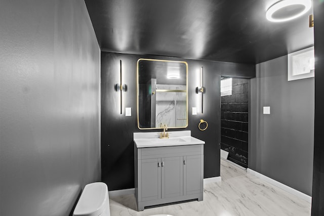 bathroom with marble finish flooring, a stall shower, toilet, and baseboards