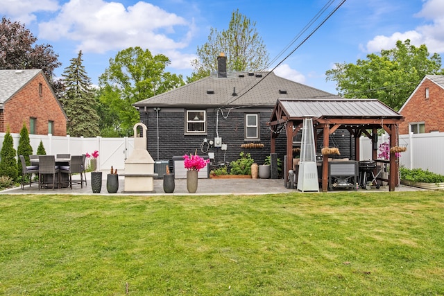 rear view of property featuring a gazebo, a patio, a chimney, and a shingled roof
