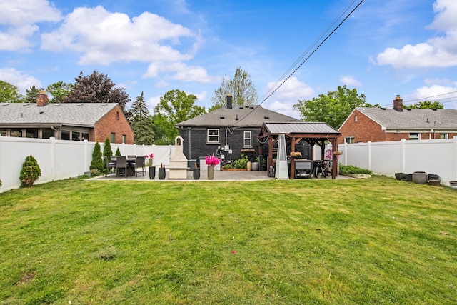 back of house with a gazebo, a patio area, and brick siding