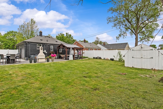 view of yard featuring a gazebo, a patio, a shed, and an outbuilding
