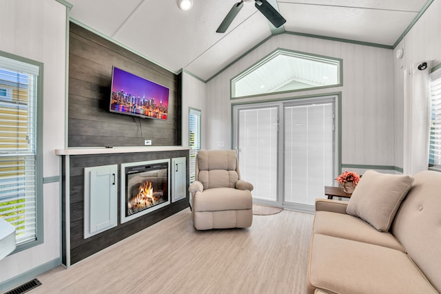2301 Water St, Port Huron, MI 48060 - living room with wood finished floors, vaulted ceiling, a ceiling fan, a large fireplace, and baseboards