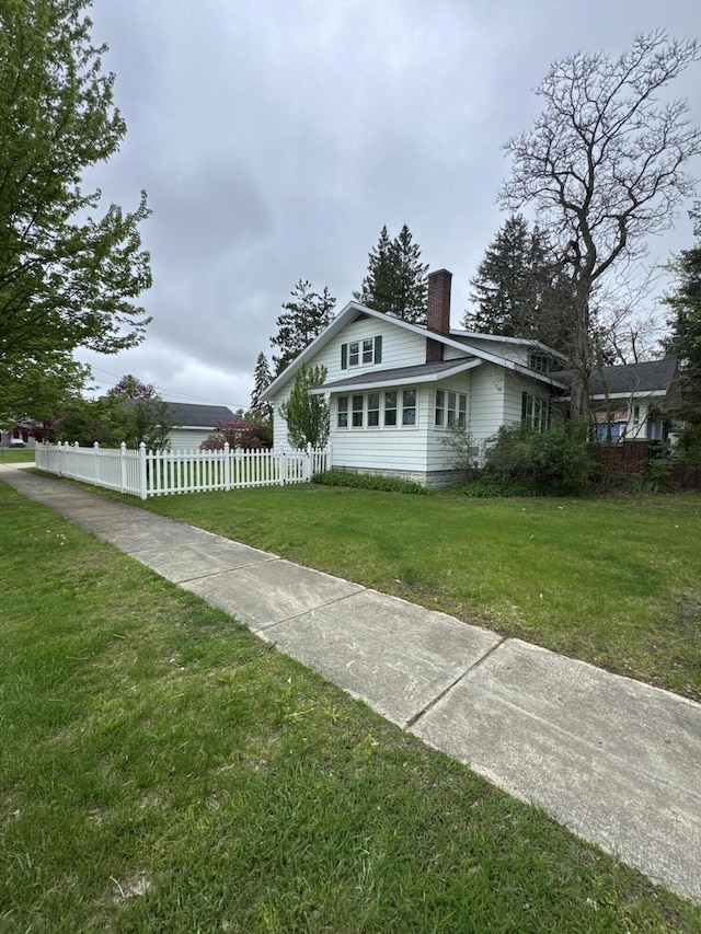 701 Chestnut St, Grayling, MI 49738 - view of front facade with a chimney