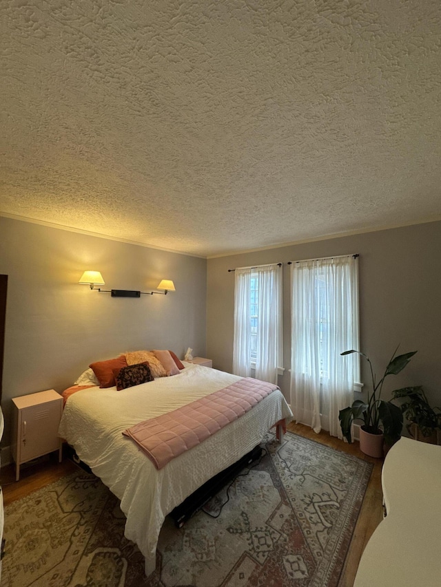 701 Chestnut St, Grayling, MI 49738 - bedroom with wood finished floors and a textured ceiling