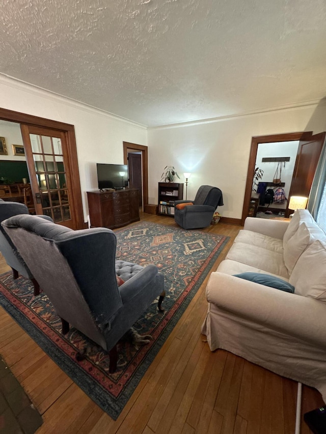 701 Chestnut St, Grayling, MI 49738 - living area featuring hardwood / wood-style flooring, a textured ceiling, and baseboards