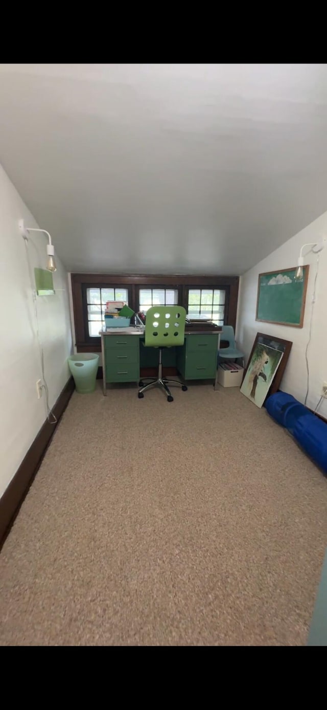 701 Chestnut St, Grayling, MI 49738 - living area featuring lofted ceiling, light colored carpet, and healthy amount of natural light