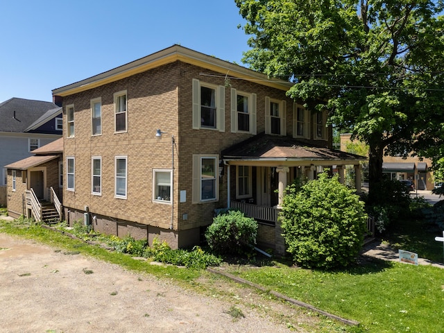 447 W Vine St, Kalamazoo, MI 49001 - view of front of property with brick siding and covered porch
